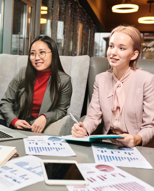 Two business owners planning with financial documents